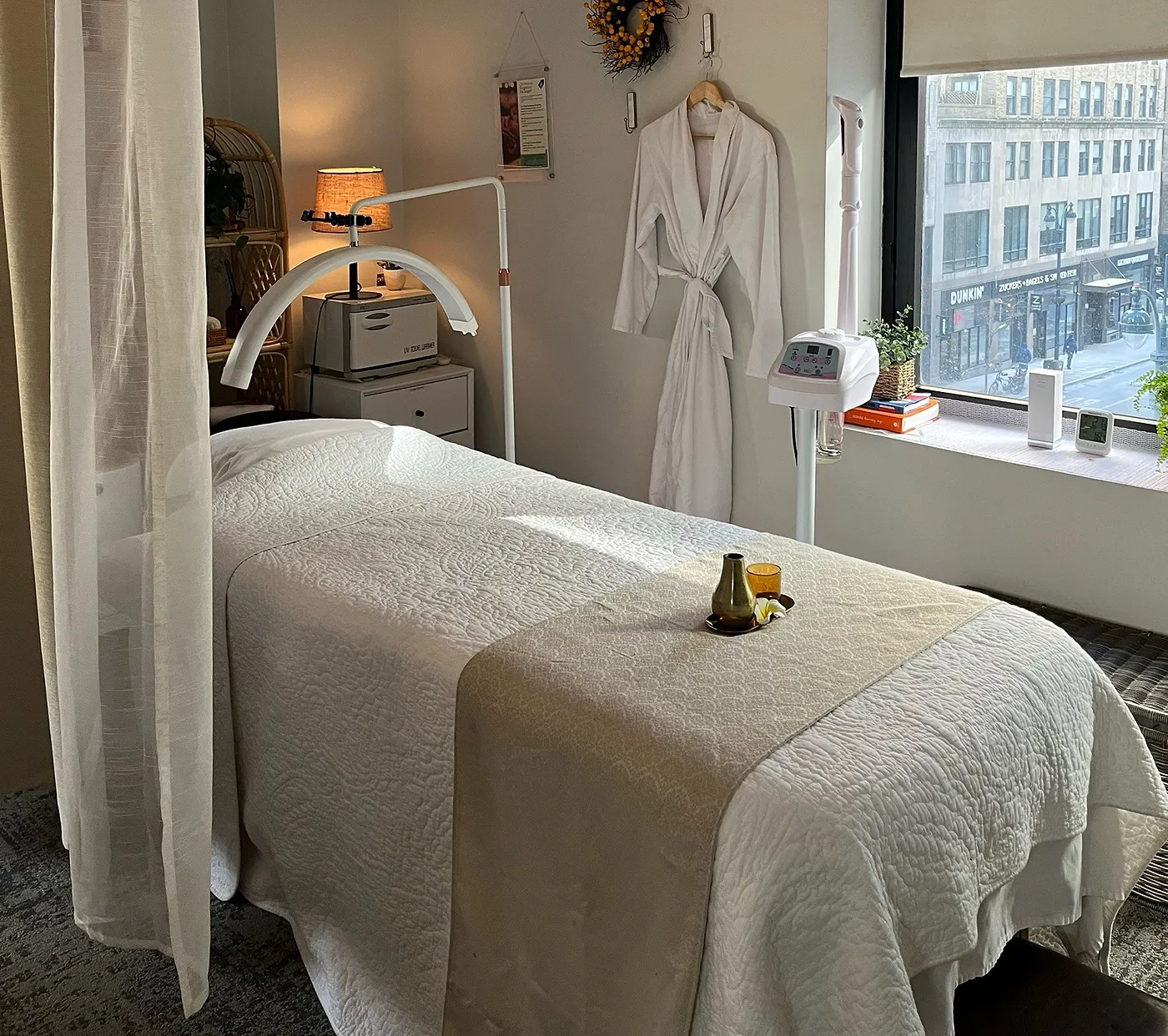 Our treatment room β a warm robe and a bed by the window